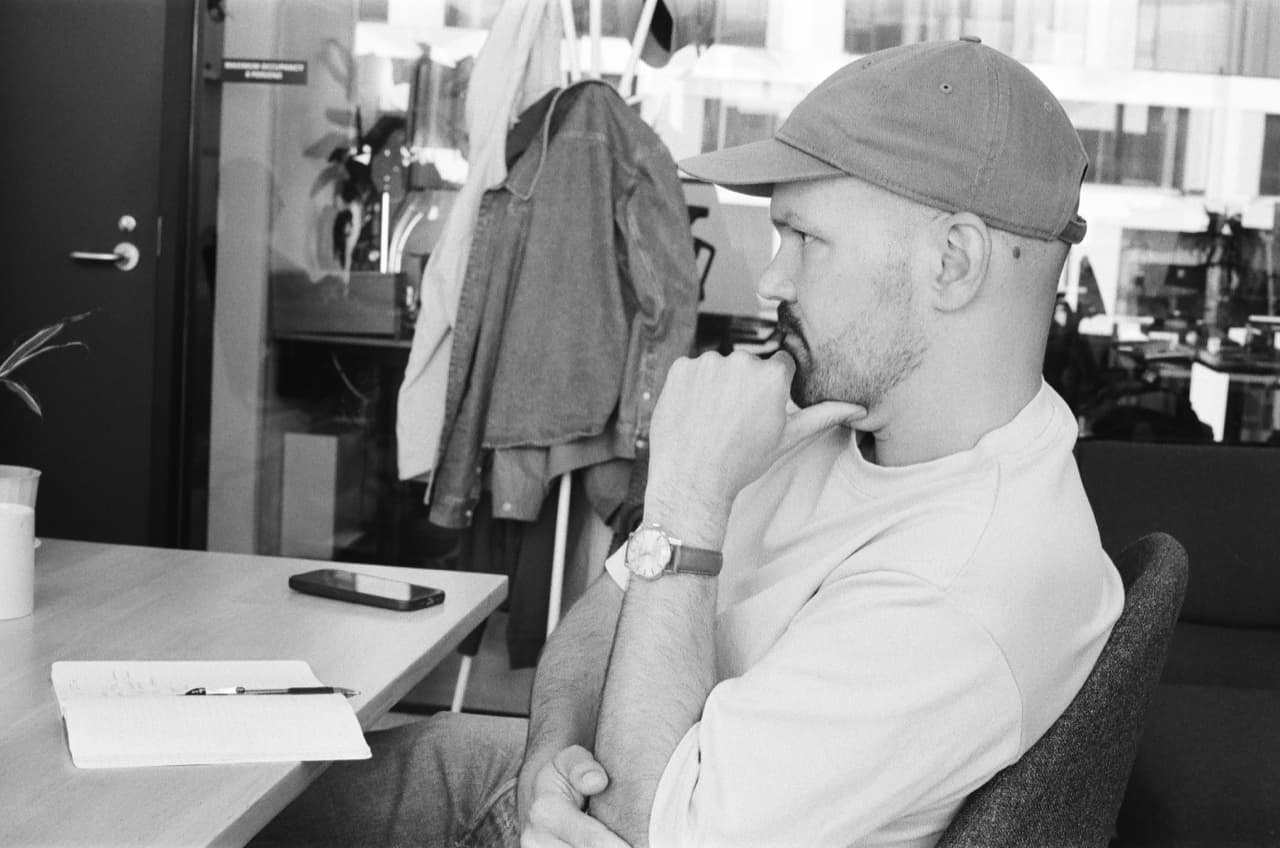 A teammate caught in thought at their desk.