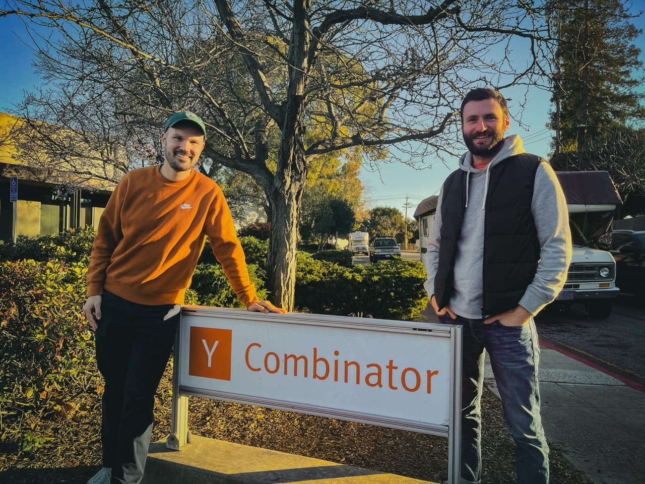 The founders in front of the Y Combinator sign.